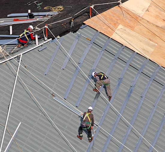 Men building roof together aerial shot